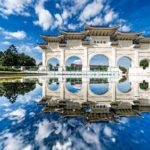 white oriental memorial archway in sunny day